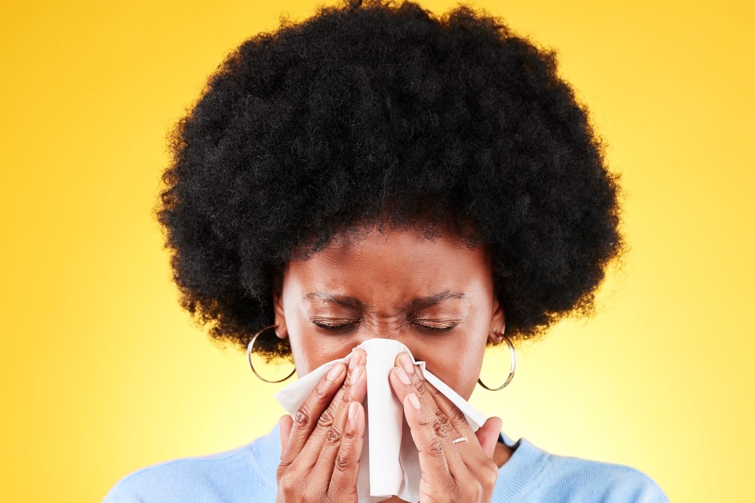 woman blowing a runny nose