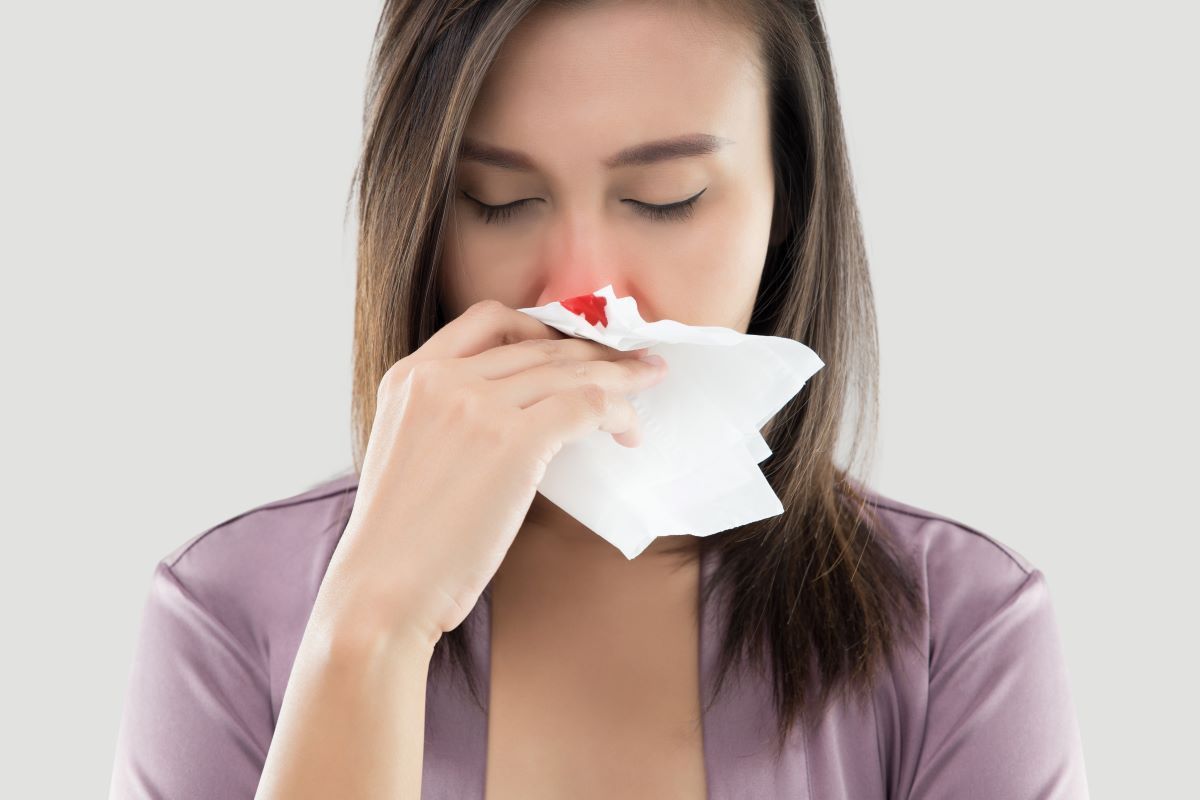 Woman with a nosebleed