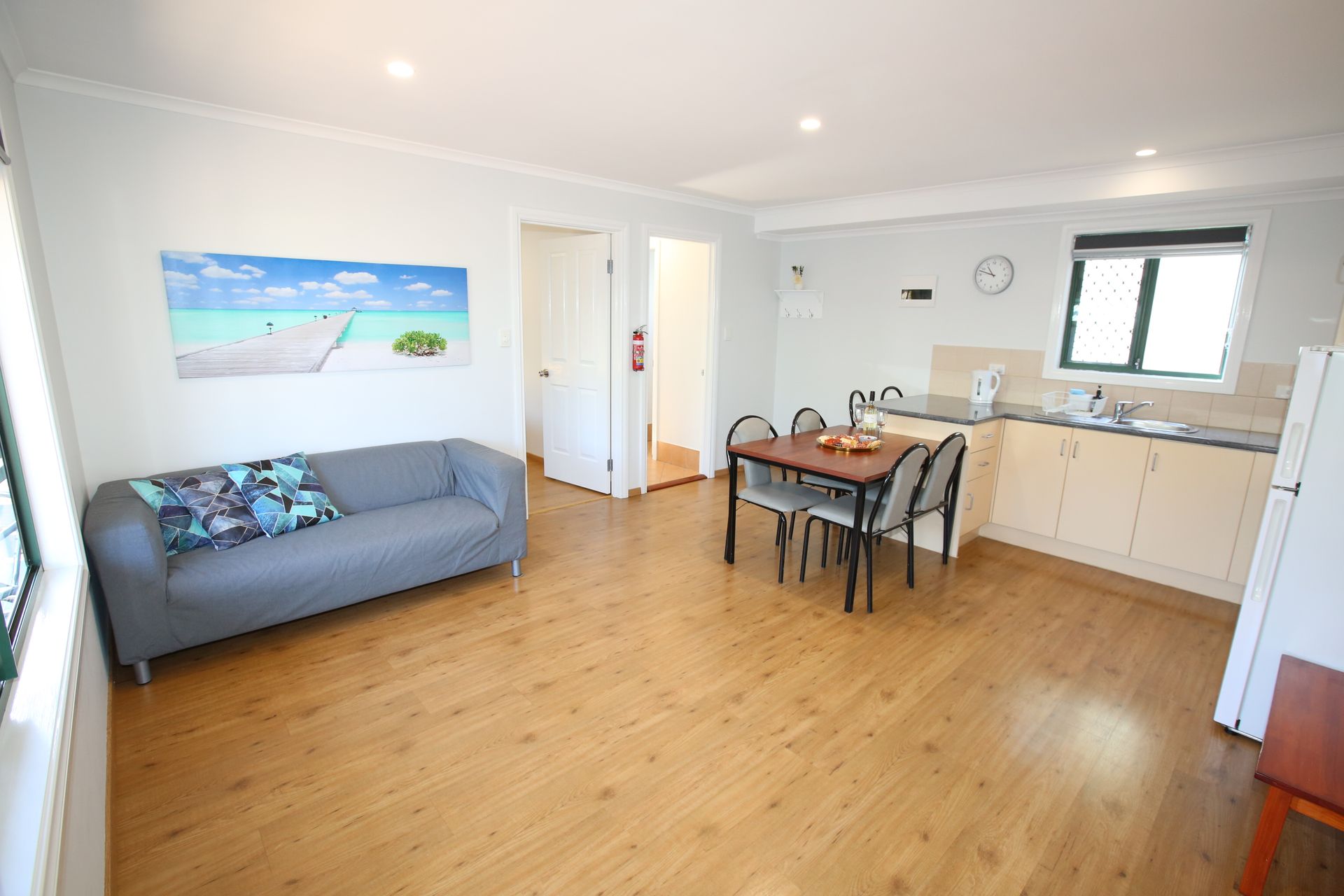 A living room with a couch , table and chairs.