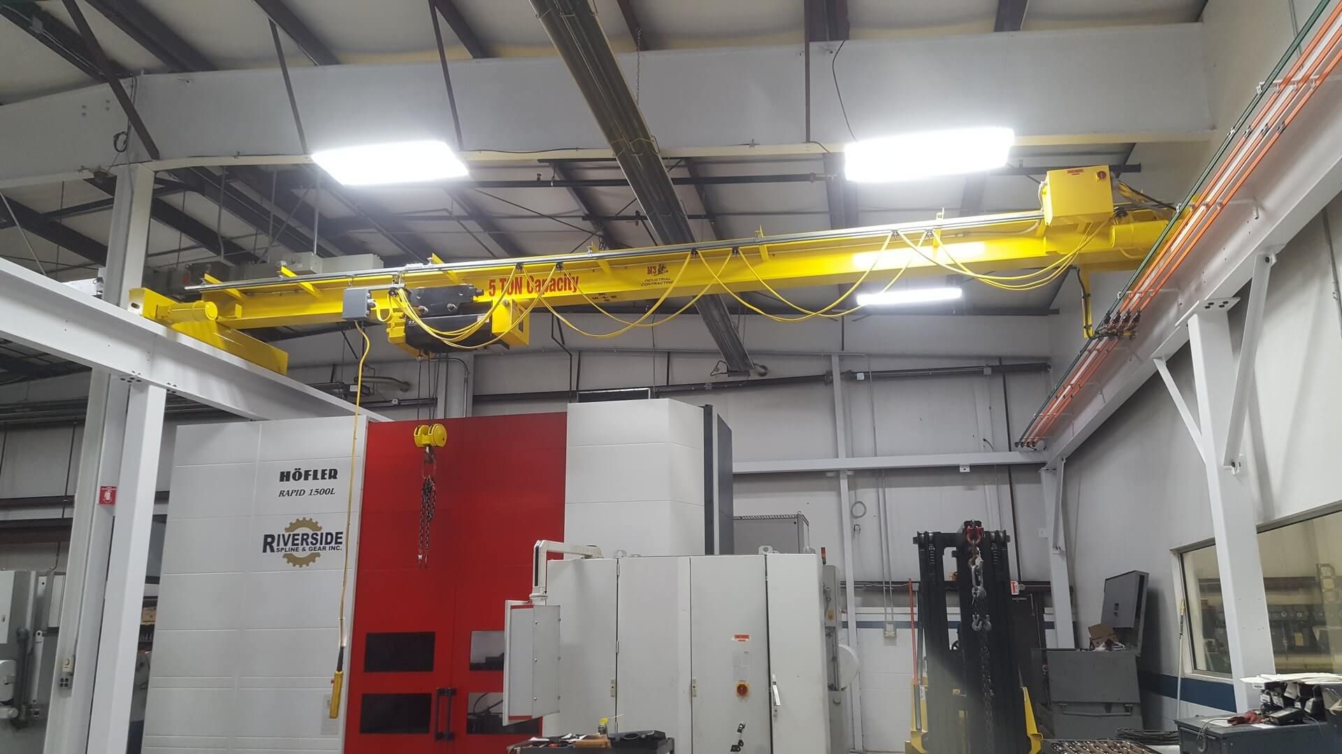 Yellow overhead crane in a factory.