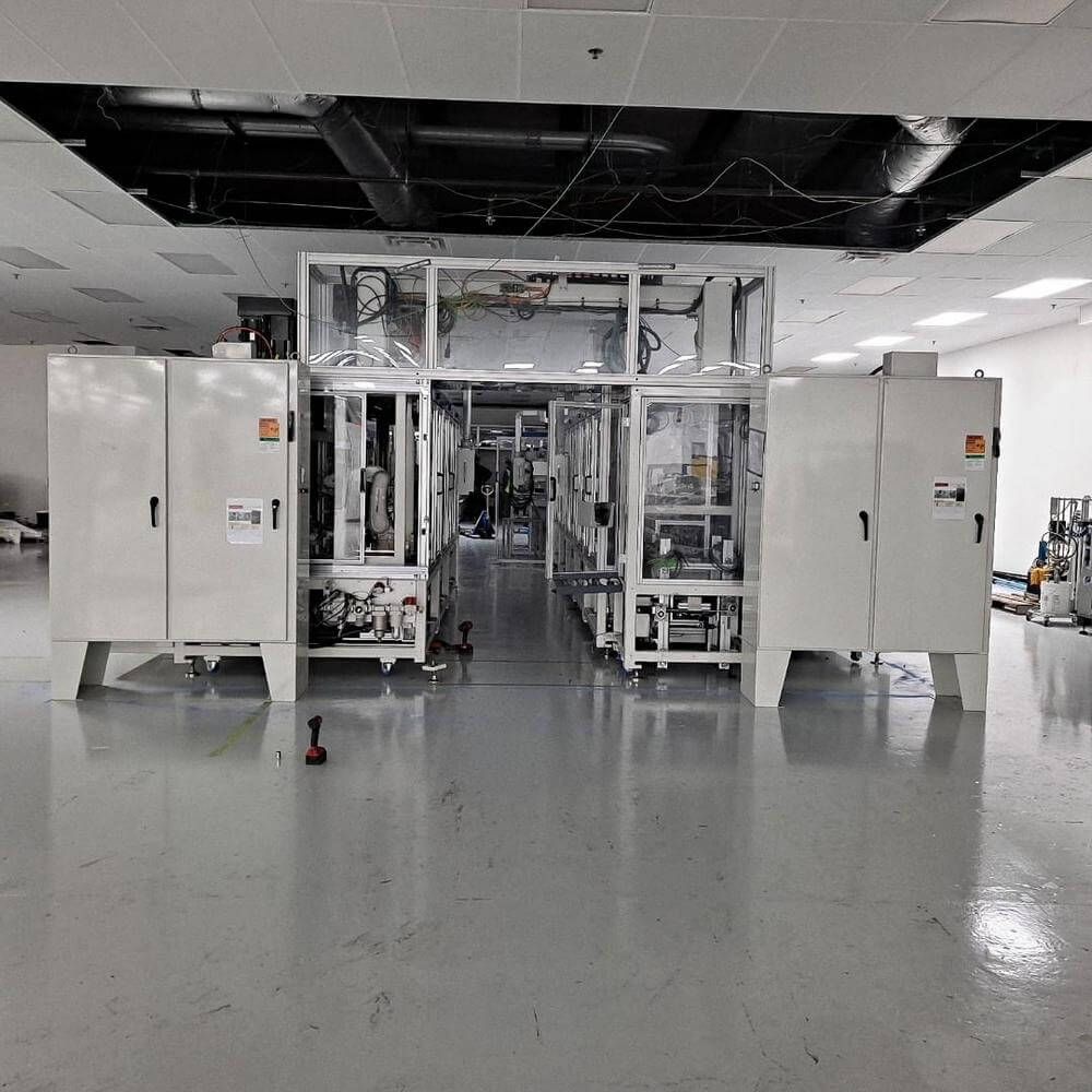 Large industrial machine in a clean, brightly lit factory setting.