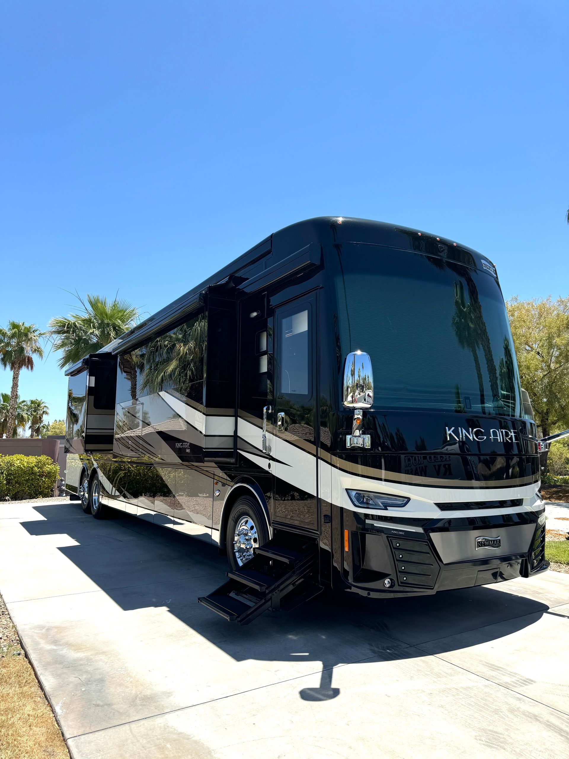 A large rv is parked on the side of the road.