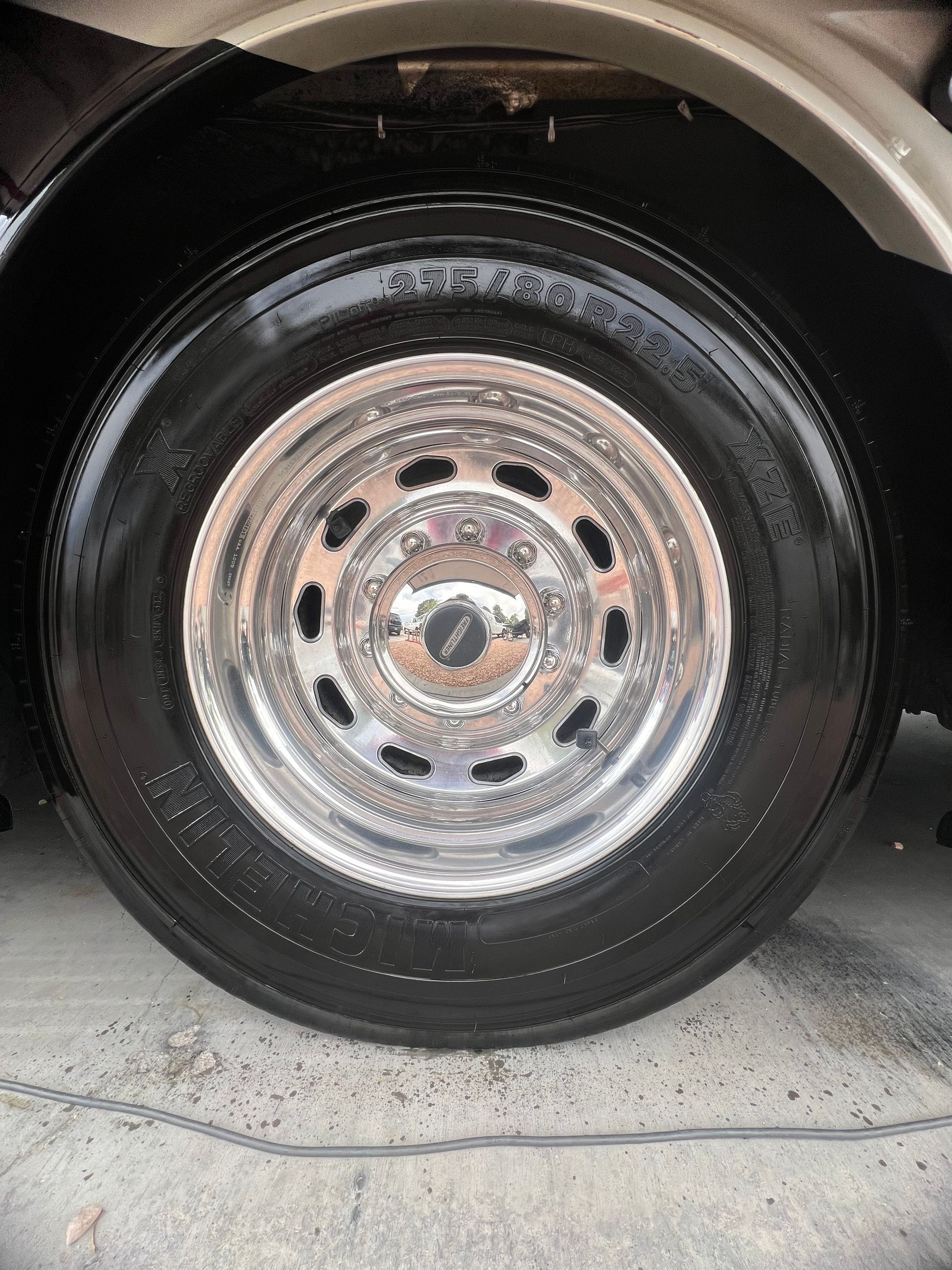 A close up of a car wheel with a chrome rim