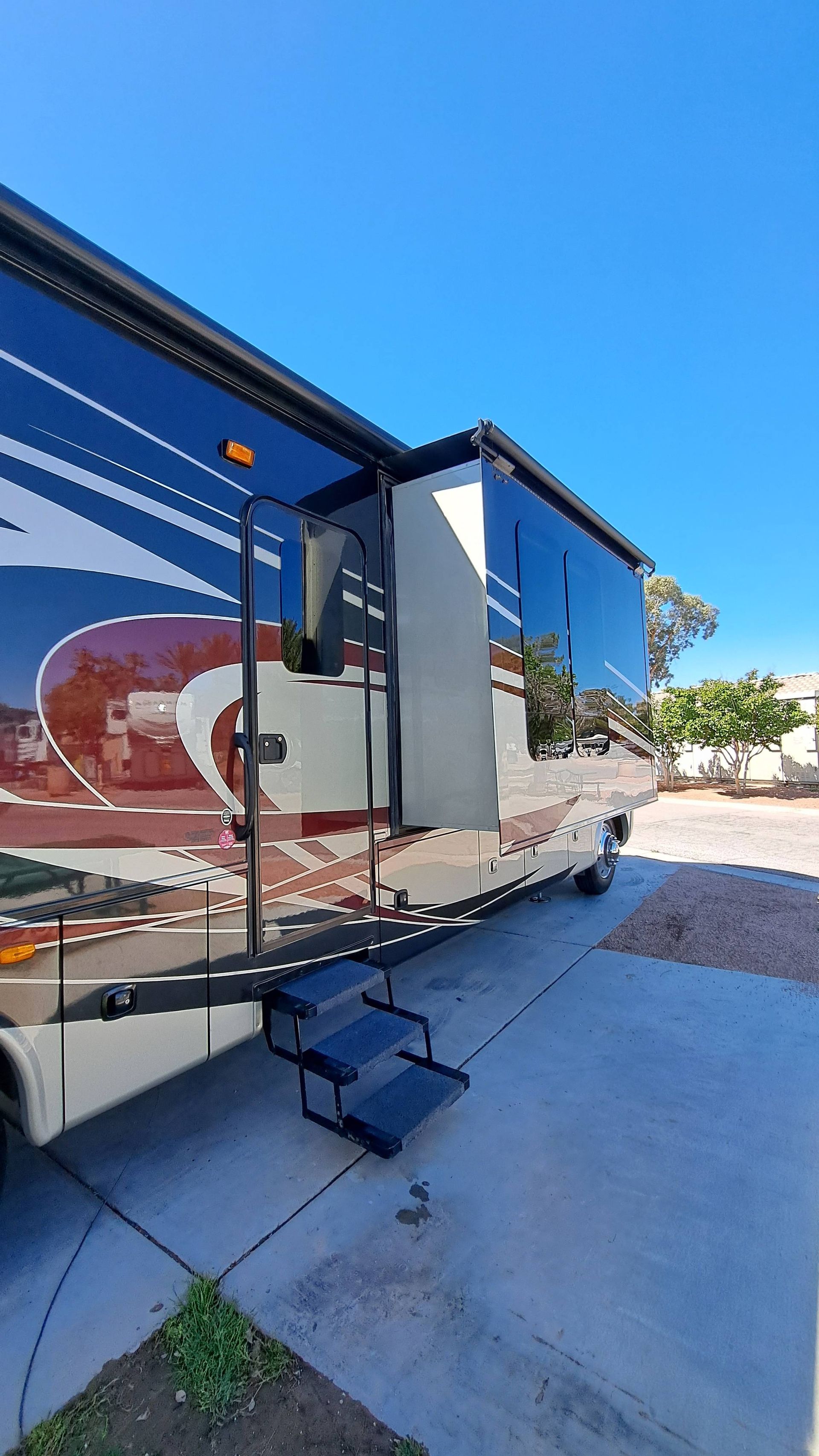 A large rv is parked in a parking lot.