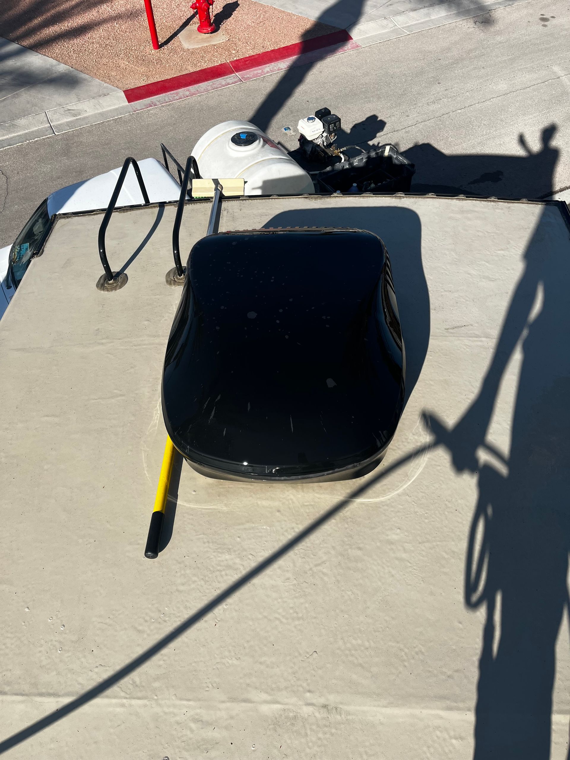 A shadow of a person is cast on a concrete surface