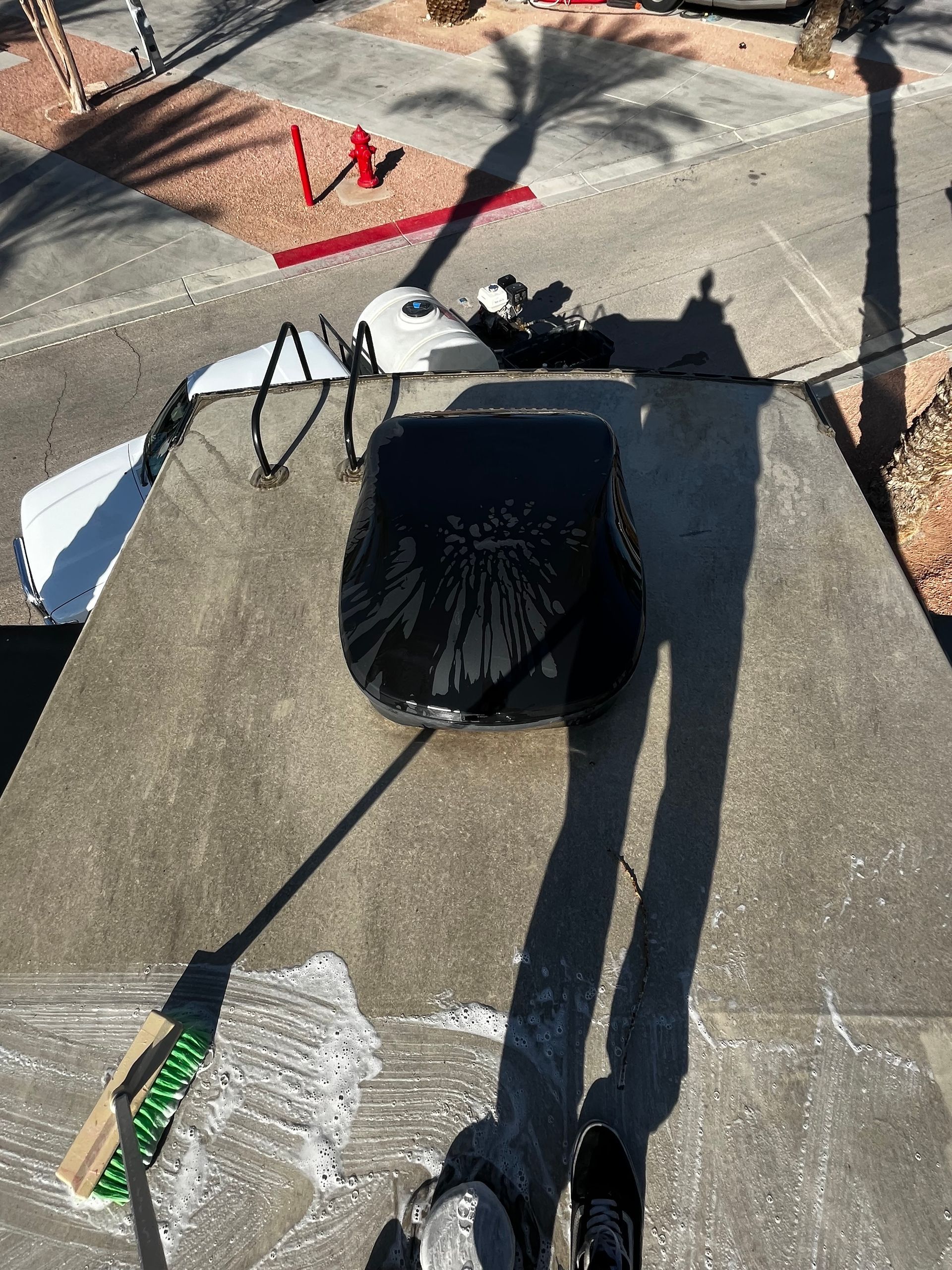 A person is standing on a concrete surface with a bag on top of it.