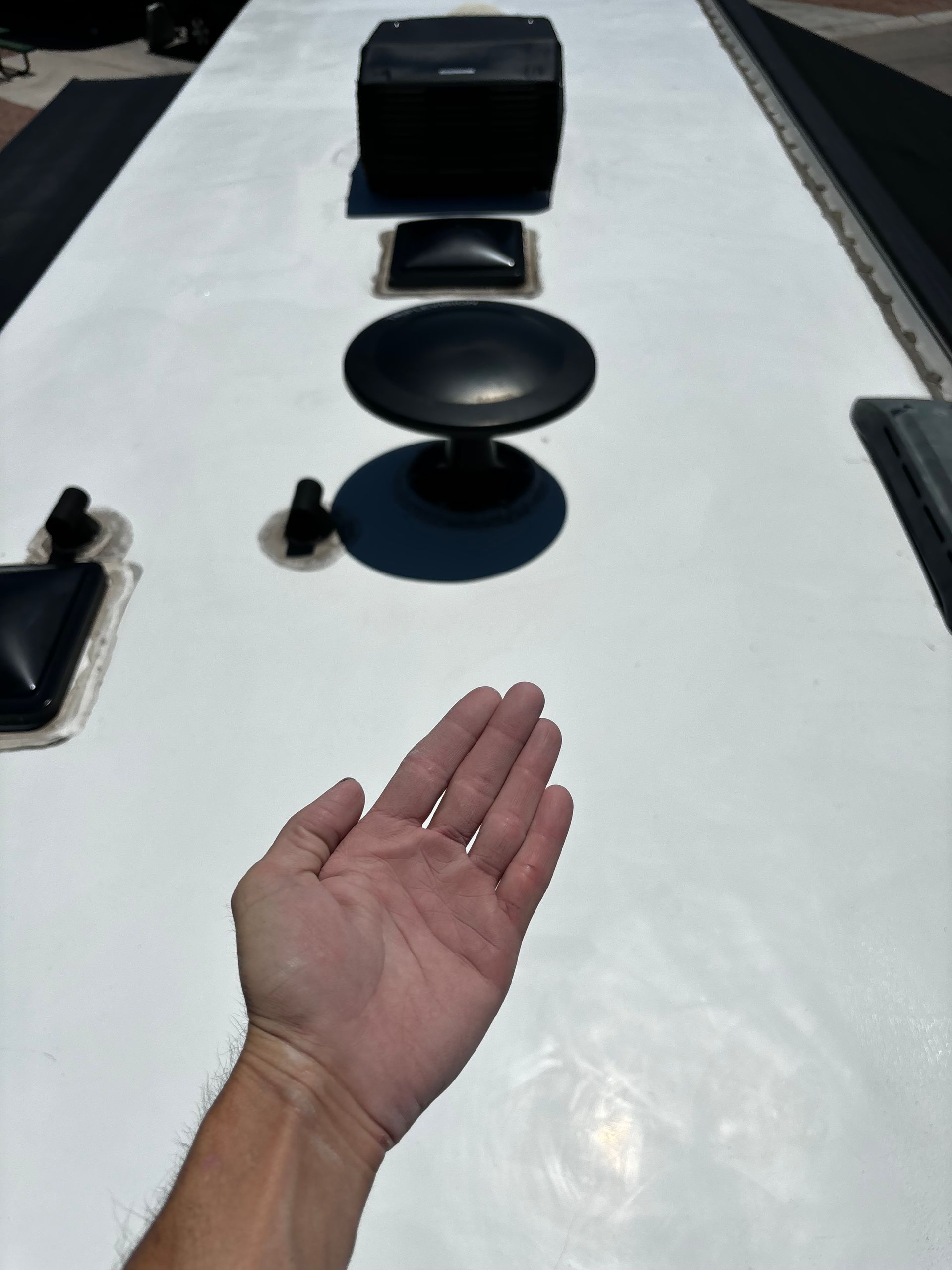 A person 's hand is reaching out towards a white surface