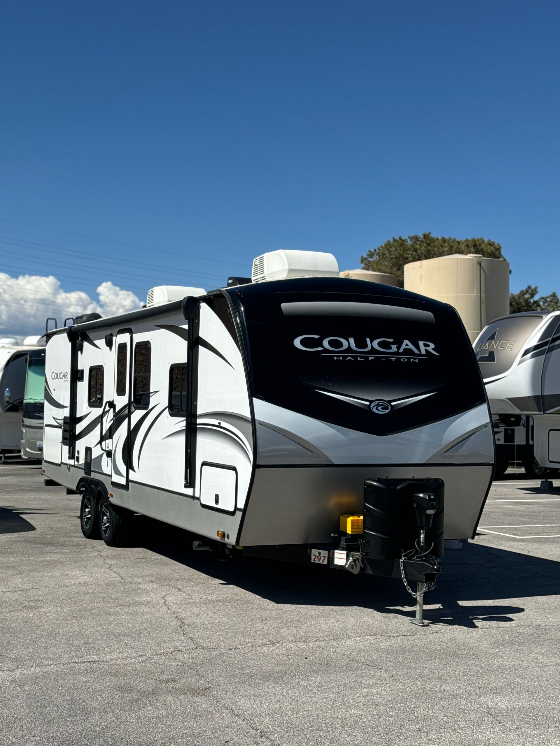 A cougar trailer is parked in a parking lot.