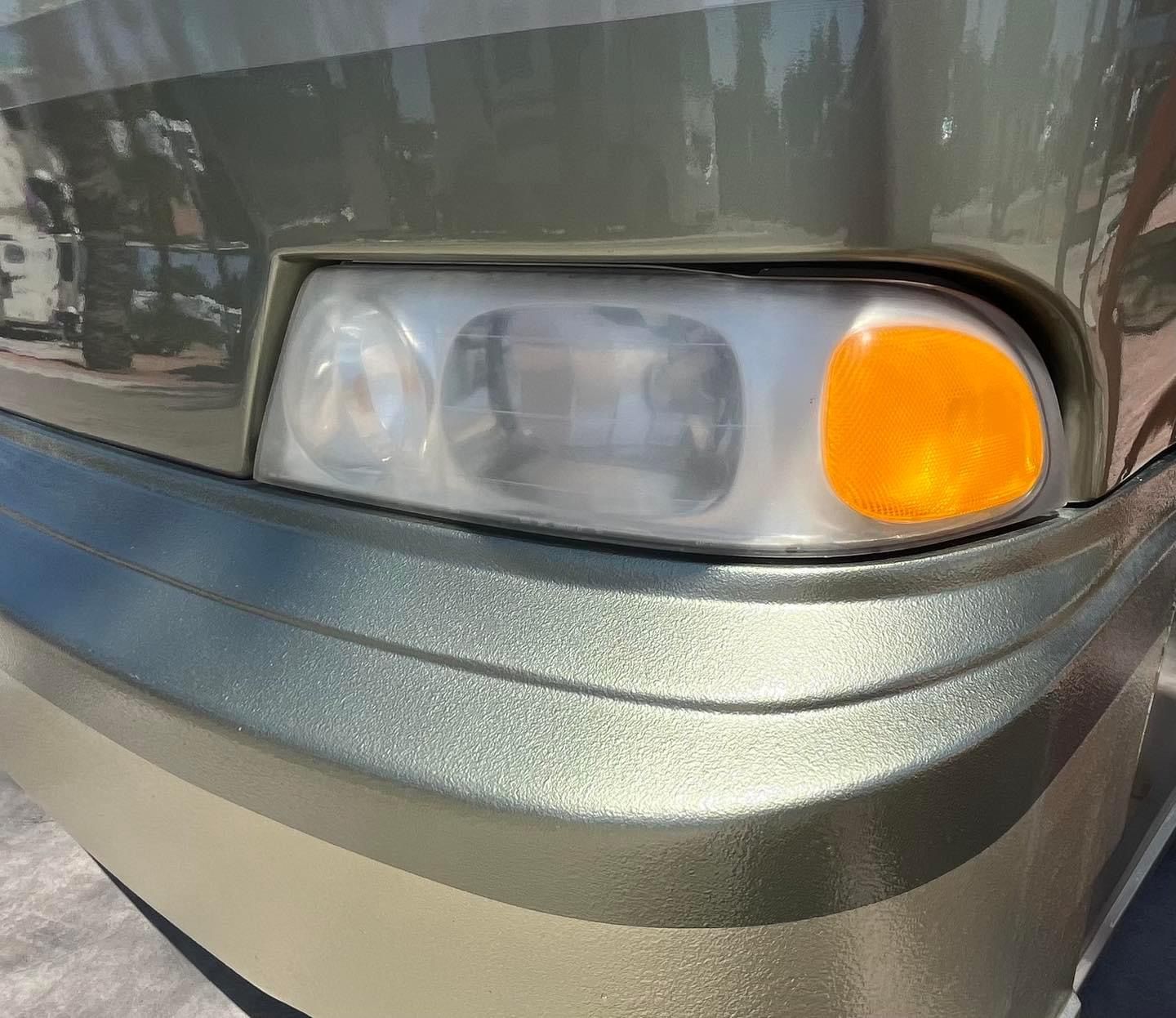 A close up of a car 's headlight and bumper