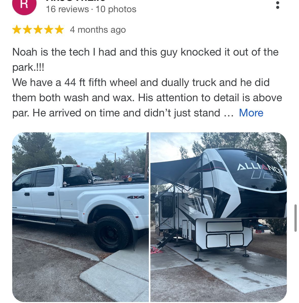 A white truck is parked in a parking lot next to a trailer.