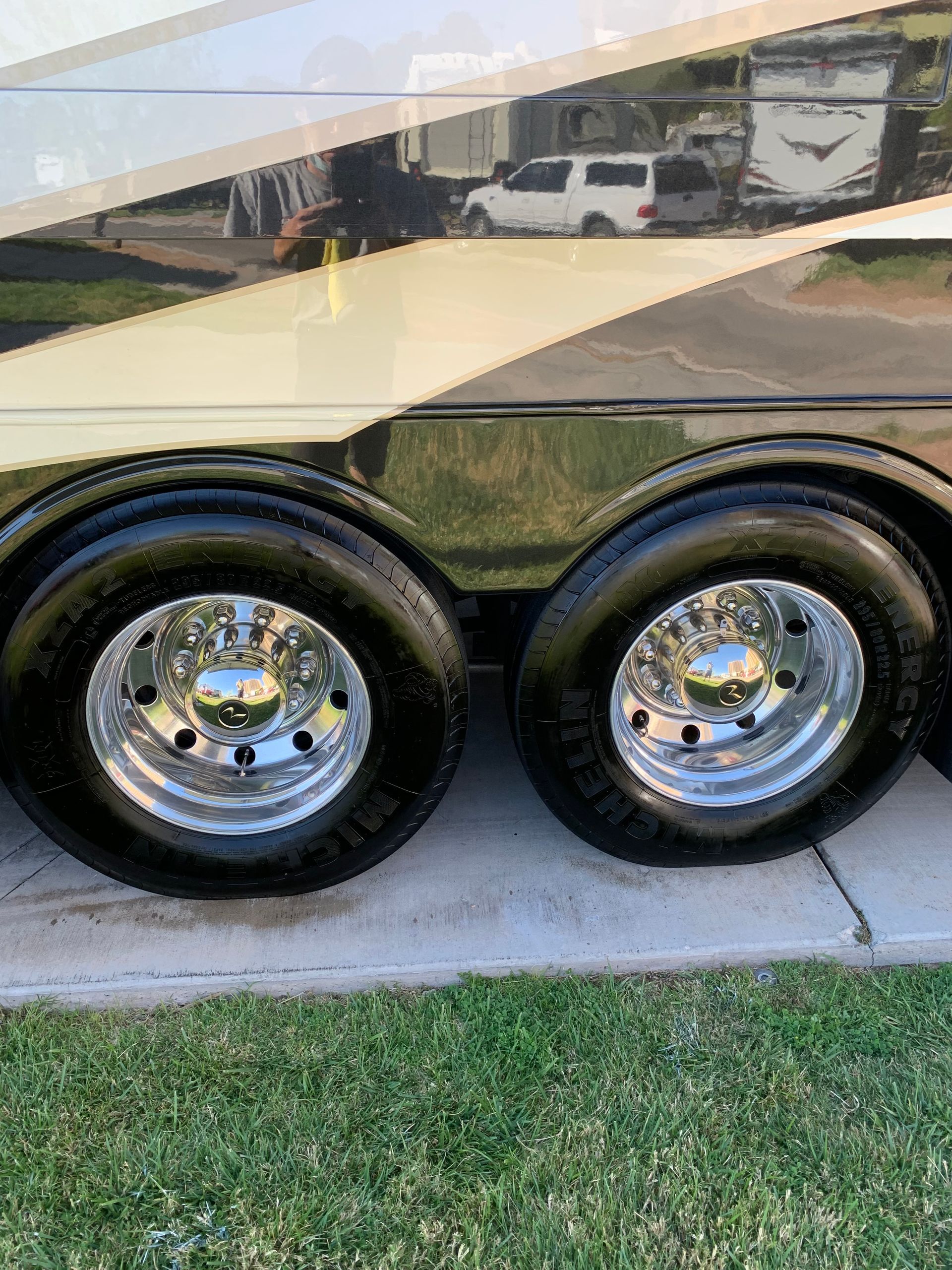 A close up of a trailer 's wheels and tires.