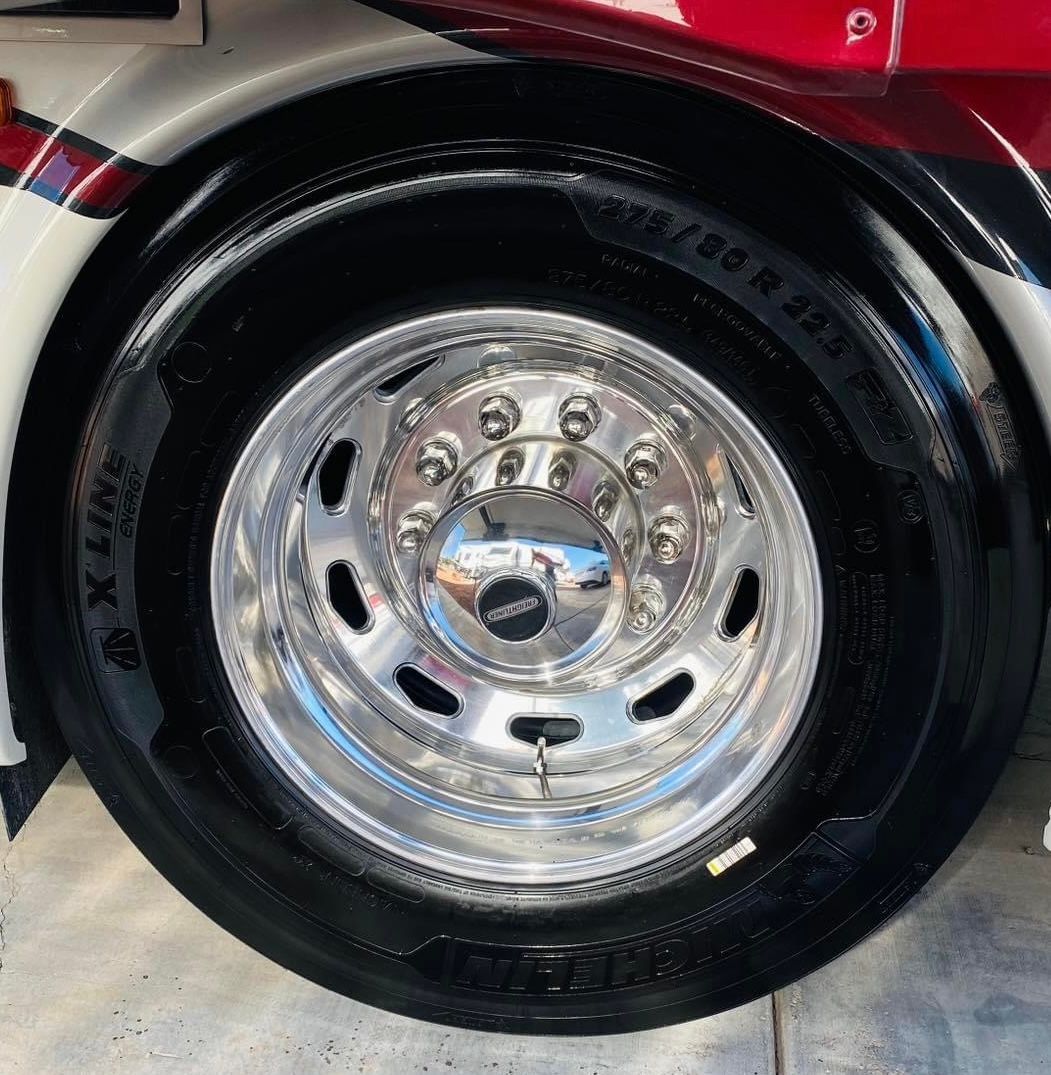 A close up of a truck tire with a chrome rim
