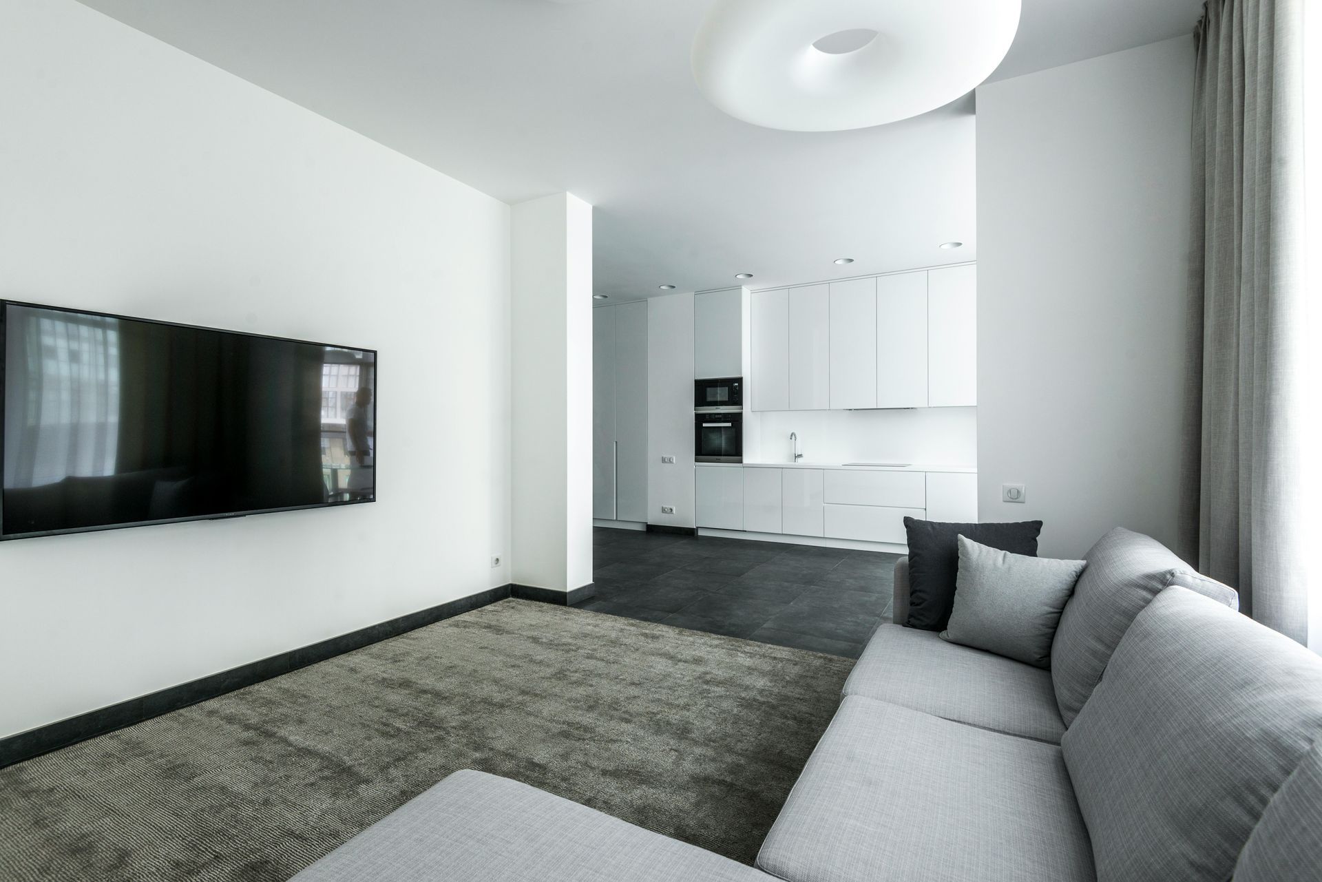 A living room with a couch and a flat screen tv