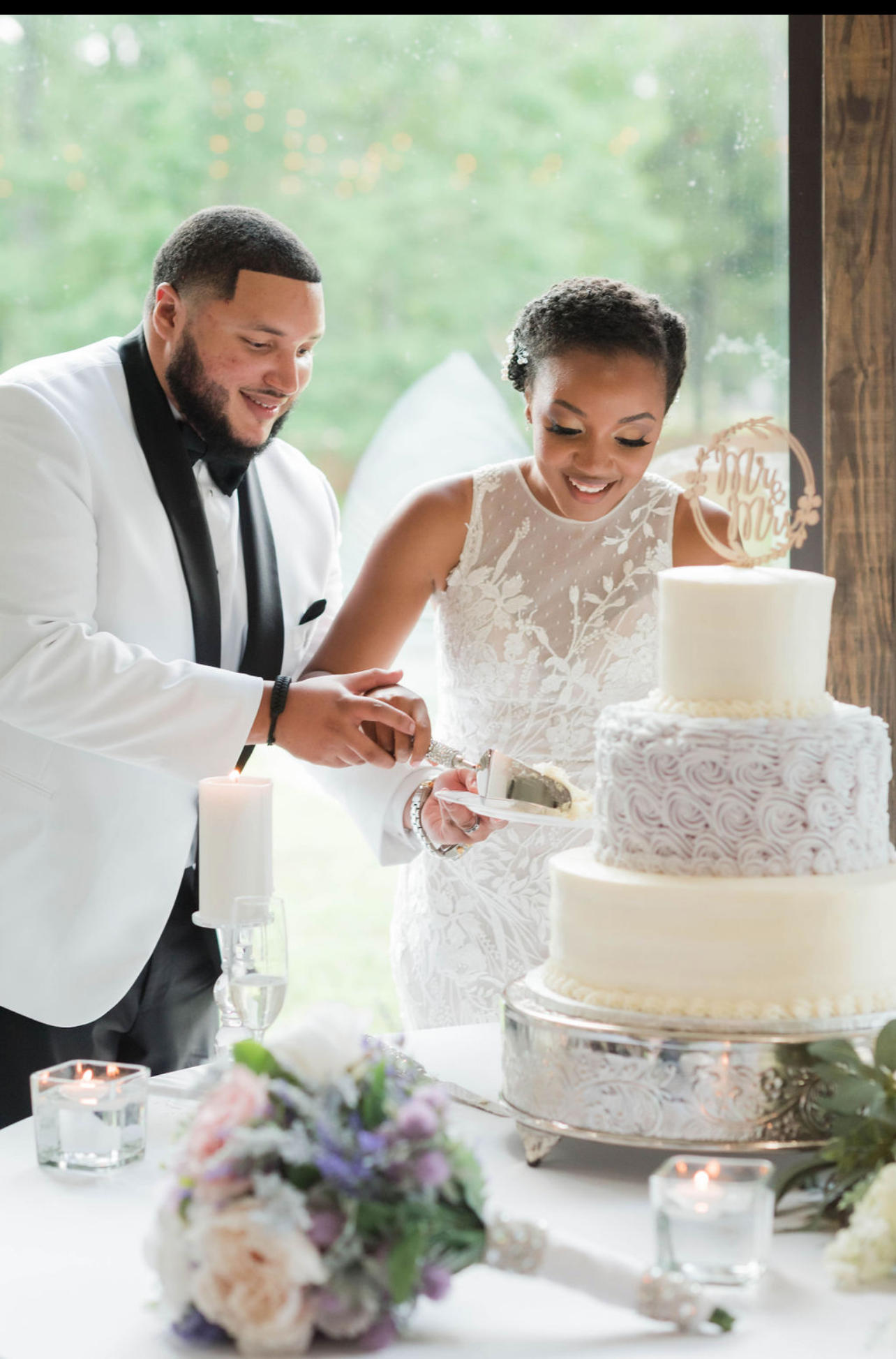 Bride and groom cutting beautiful wedding cake