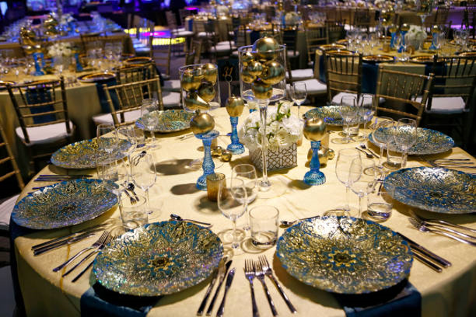 Elegant event space decorated in teal and gold with upscale table design