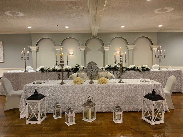 Reception hall with black white and silver decor and styled wedding tables