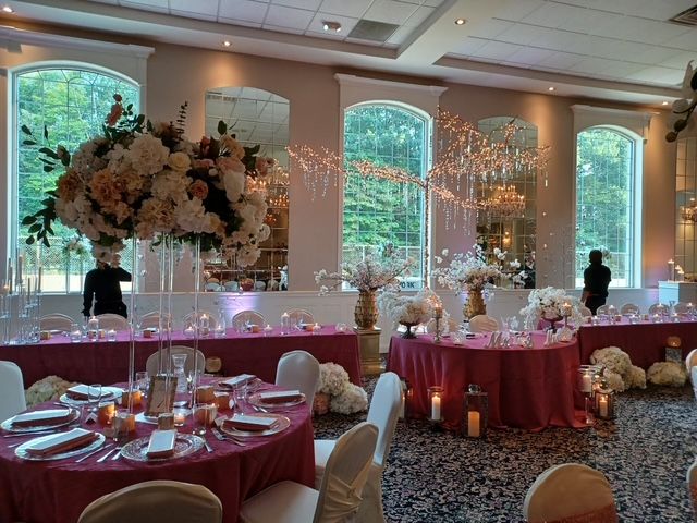 Decorated ballroom with pink and wine decor and  cohesive table styling 