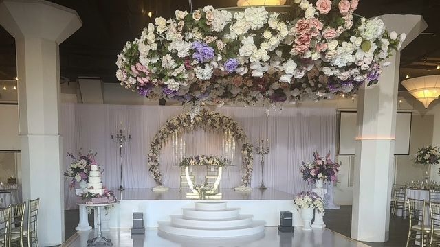 Buffalo event hall transformed for a wedding reception with elegant decor and floral chandelier