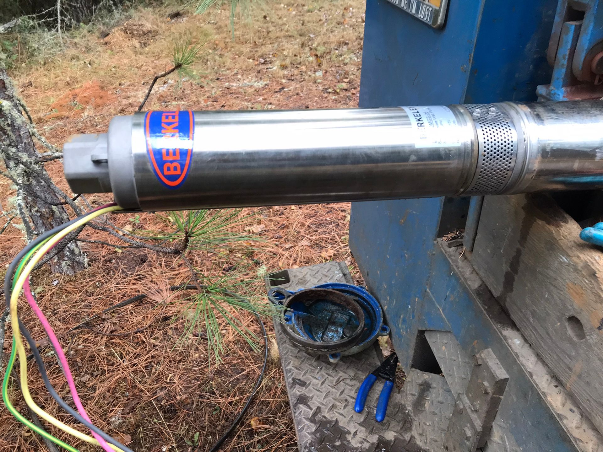 A close up of a water pump with wires attached to it.