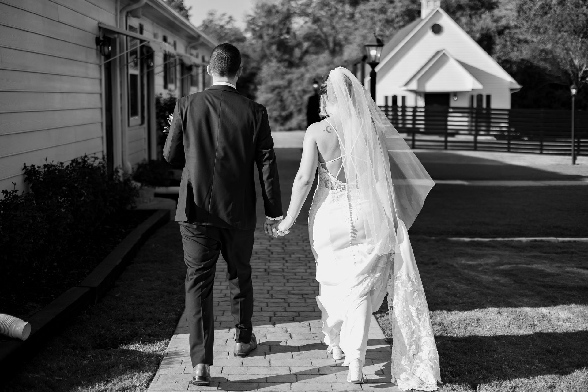 Black-and-white photo of a couple sharing a moment at Venue 311 on their wedding day.