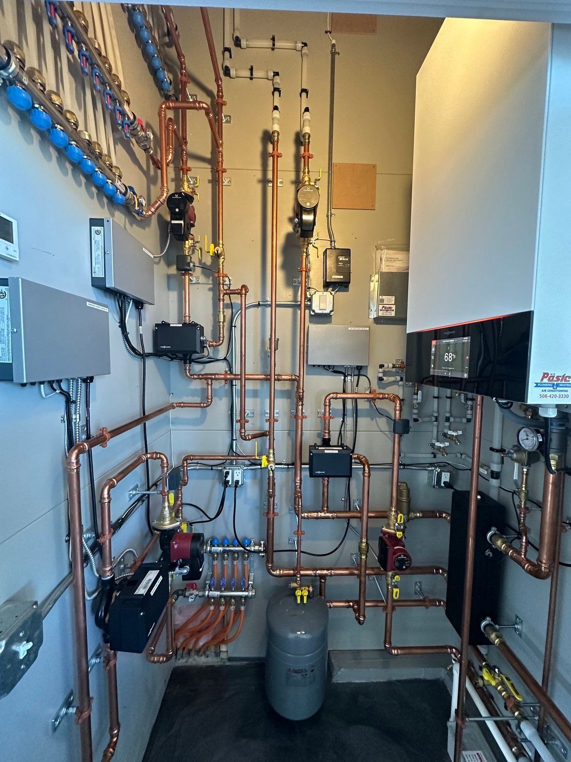Copper pipes and heating equipment installed in a utility room.