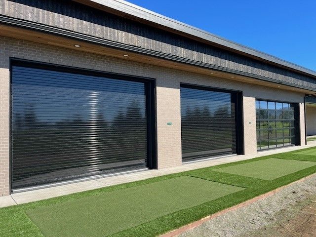 A building with a lot of windows and a lawn in front of it