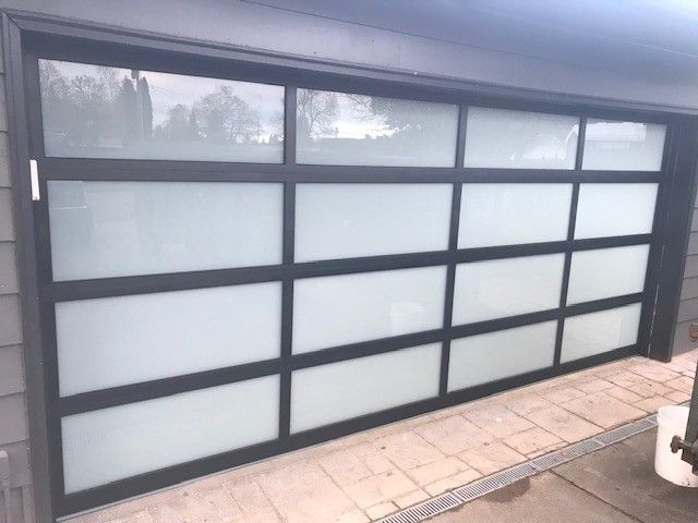 A garage door with a lot of windows and a black frame.