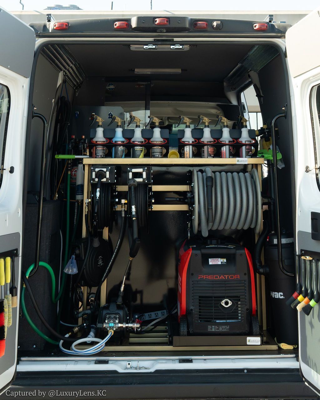 Black Giraffe Tools air hose reel, with gray hose coiled.