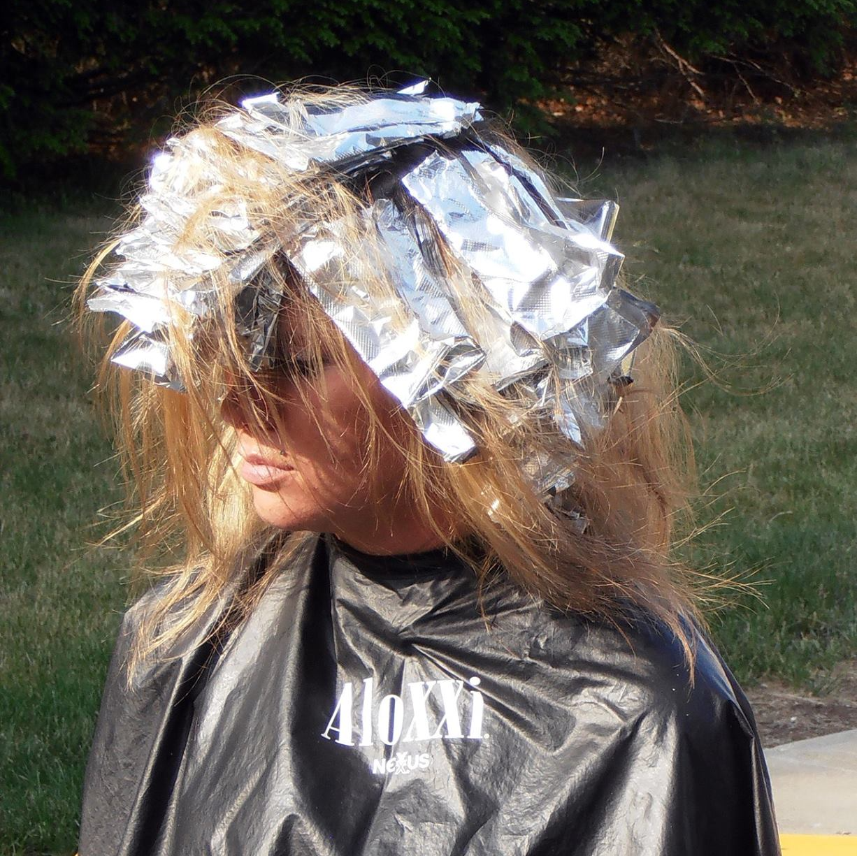 A woman wearing a black cape with the word aloha on it