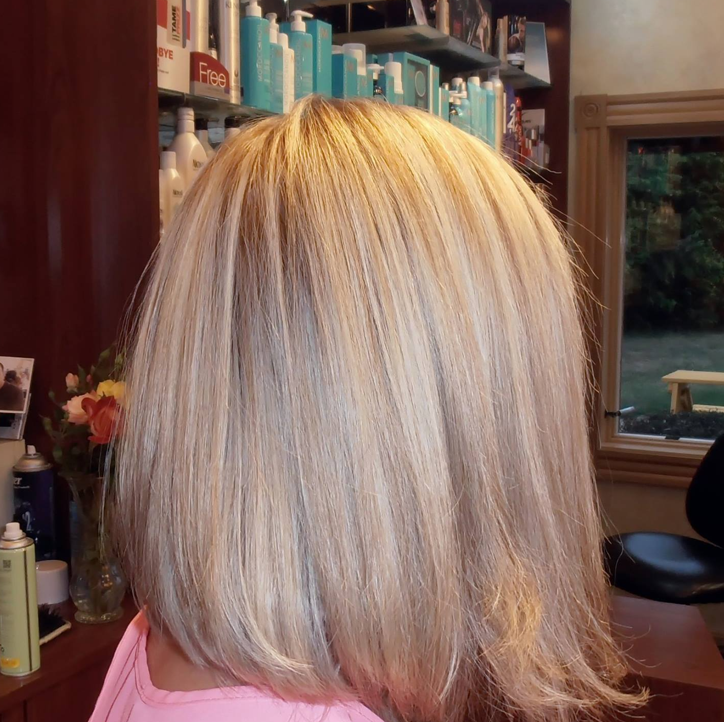A woman is getting her hair done in a salon