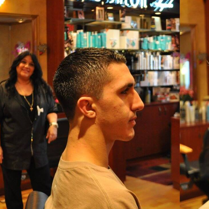 A man is getting his hair cut in a salon