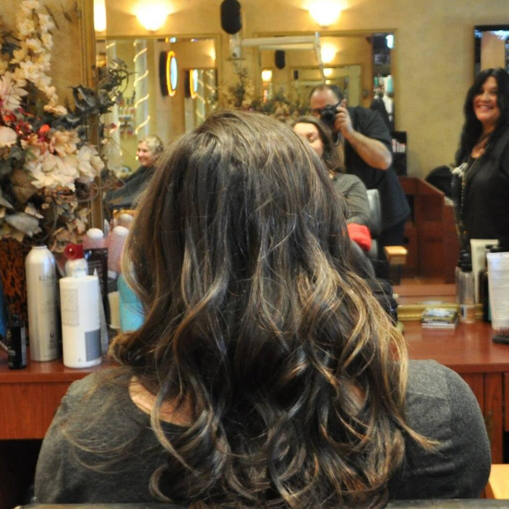 A woman is getting her hair done in a salon