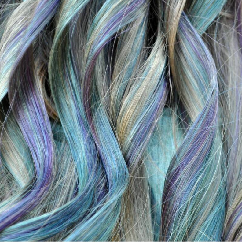 A close up of a person 's hair with blue and purple highlights