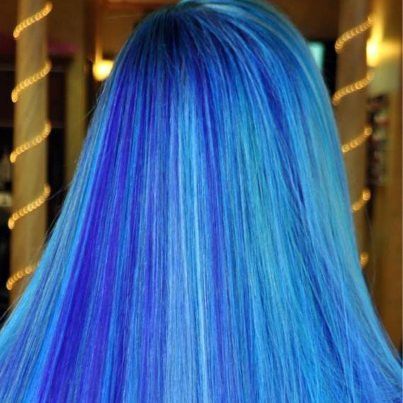 The back of a woman 's head with long blue hair