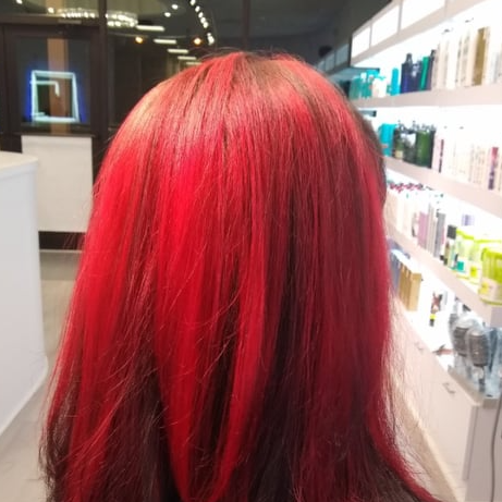 A woman with red hair is standing in a store