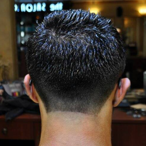 The back of a man 's head with a very short haircut