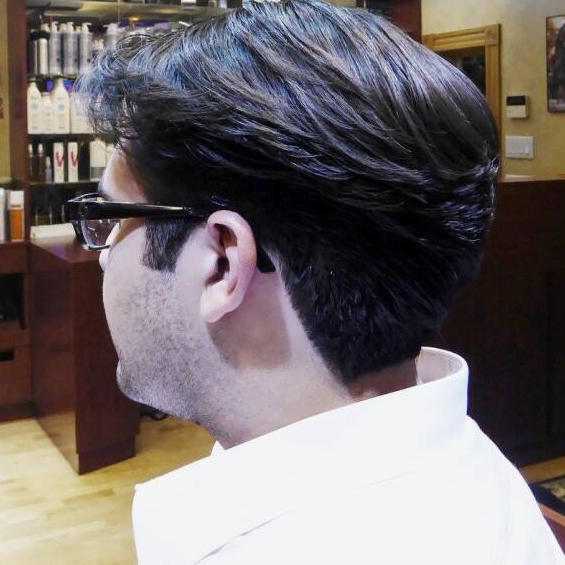 A man is wearing glasses and a white shirt