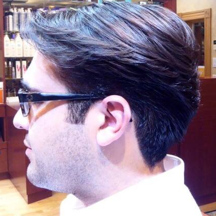 A man is wearing glasses and a white shirt