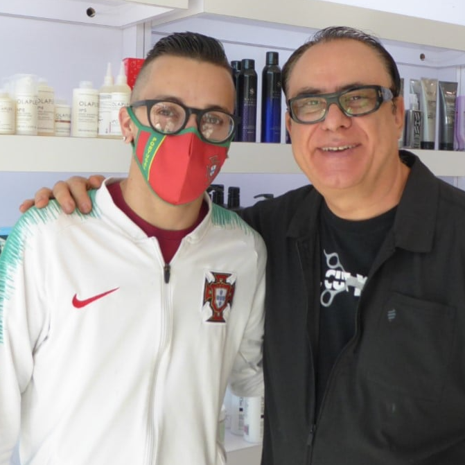 Two men posing for a picture one wearing a nike jacket