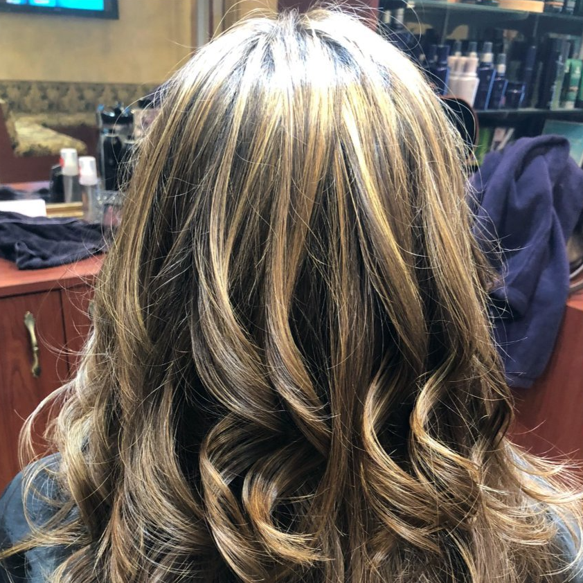 A woman is getting her hair done in a salon