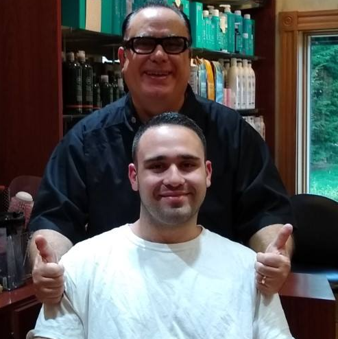 A man giving a thumbs up next to another man