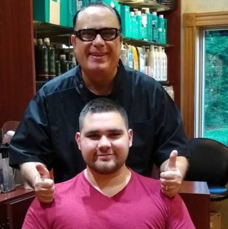 A man giving a thumbs up next to another man