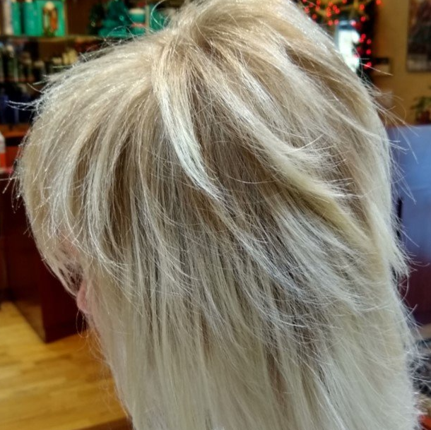 A close up of a woman 's blonde hair in a salon.