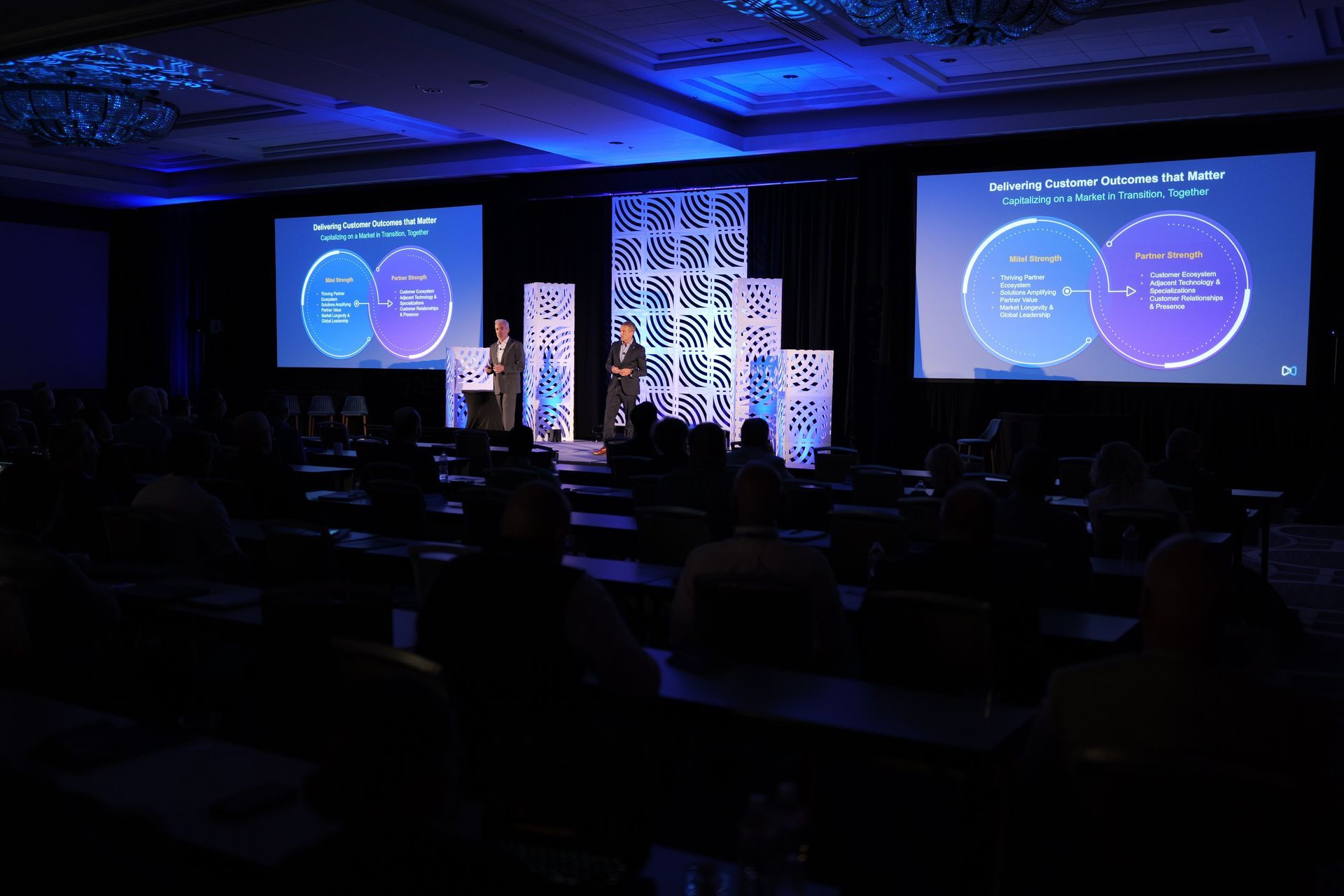 Two Mitel leaders on stage at the Mitel Executive Partner Summit.