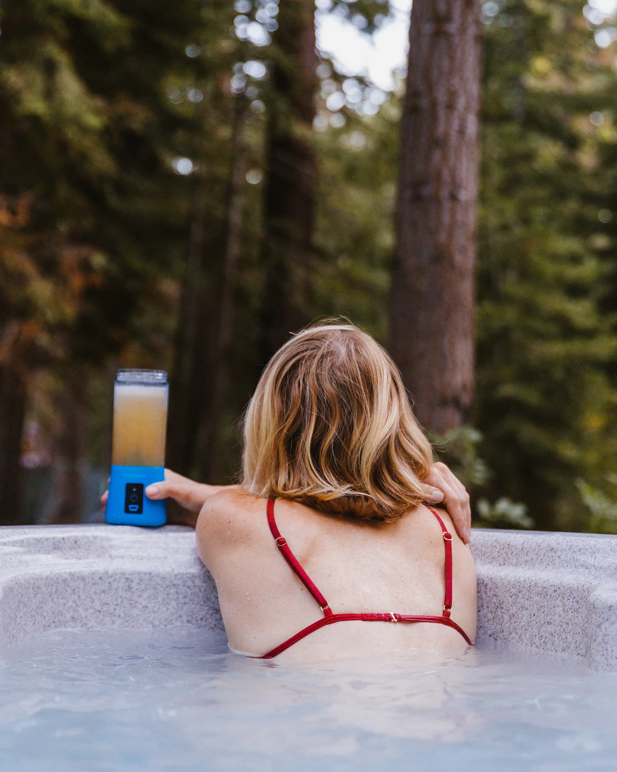 woman in hot tub in the woods