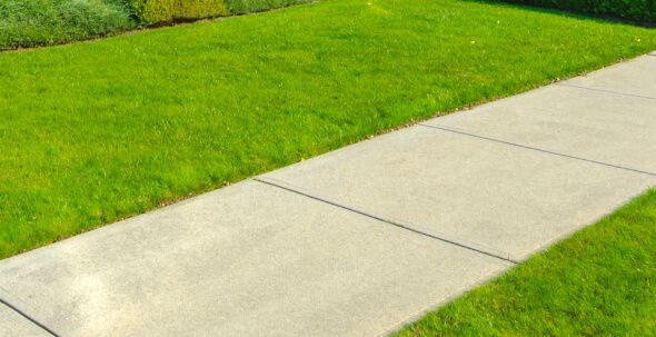 Concrete sidewalk installation in NJ with proper grading, compacted base, control joints, and safe traction finish