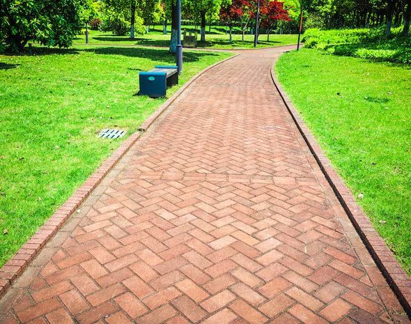 Sidewalk repair in New Jersey addressing cracked slabs, tree root damage, and uneven walking surfaces