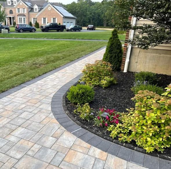 Professional landscape installation process in Hackettstown NJ including grading, drainage correction, soil preparation, proper planting, and complete property cleanup