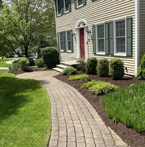 Common landscaping problems in New Jersey including overgrown shrubs, weed-filled mulch beds, poor drainage near foundation, and aging yard design in Hackettstown NJ