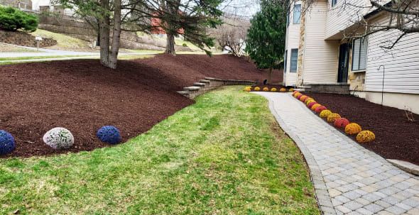 Landscape maintenance with mulch refresh, plant replacement, and continuous yard health monitoring for residential properties
